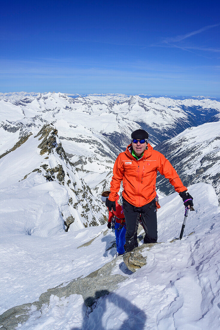 Two persons back-country skiing ascending with ice axe and crampons towards Dreiherrnspitze, Dreiherrnspitze, valley of Ahrntal, Hohe Tauern range, South Tyrol, Italy