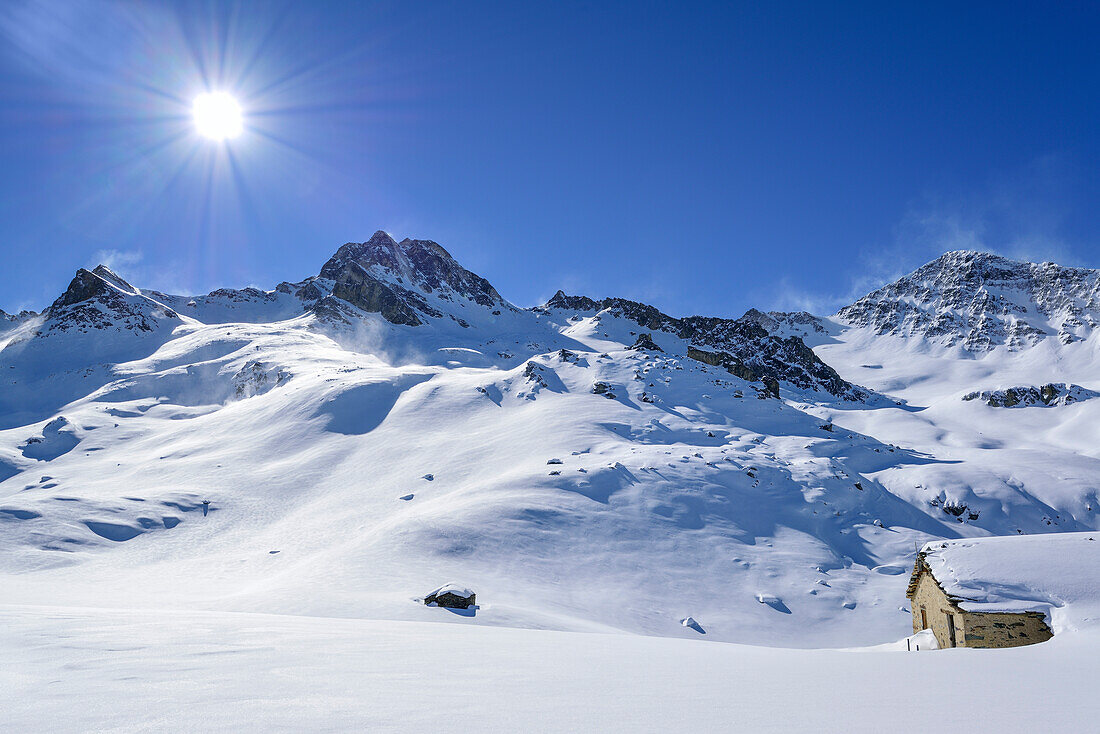 Snow covered alpine hut in front of Rocca La Marchisa and Cima Sebolet, Rocca La Marchisa, Valle Varaita, Cottian Alps, Piedmont, Italy