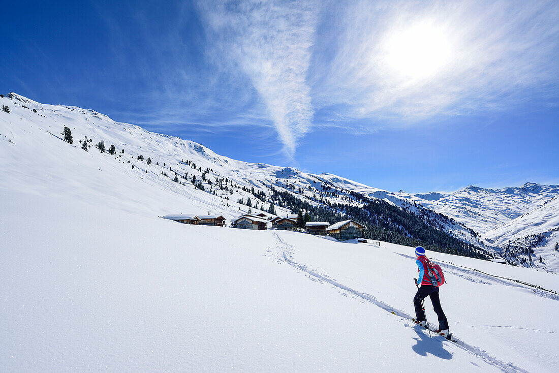Woman back-country skiing ascending towards Gilfert, view to Nonsalm, Gilfert, Tux Alps, Tyrol, Austria