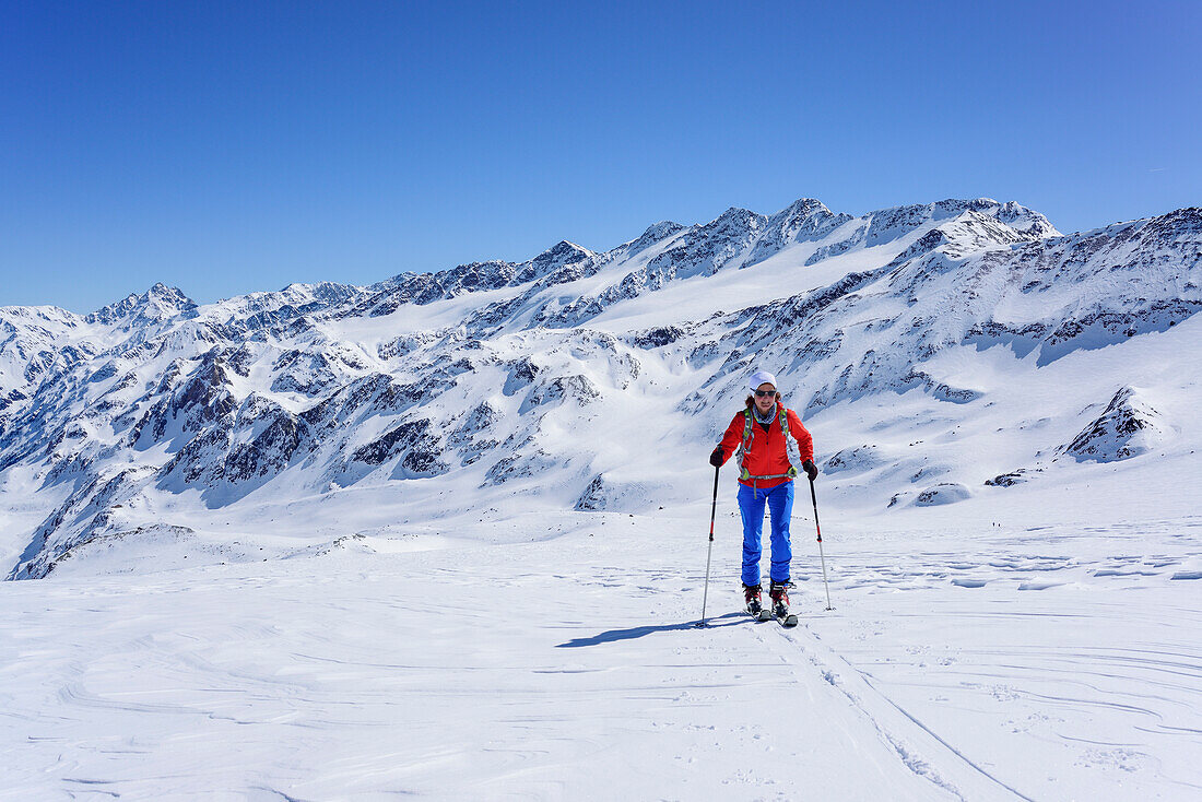 Woman back-country skiing ascending towards Monte Cevedale, Zufrittspitze and Cima Venezia in the background, Monte Cevedale, valley of Martell, Ortler range, South Tyrol, Italy