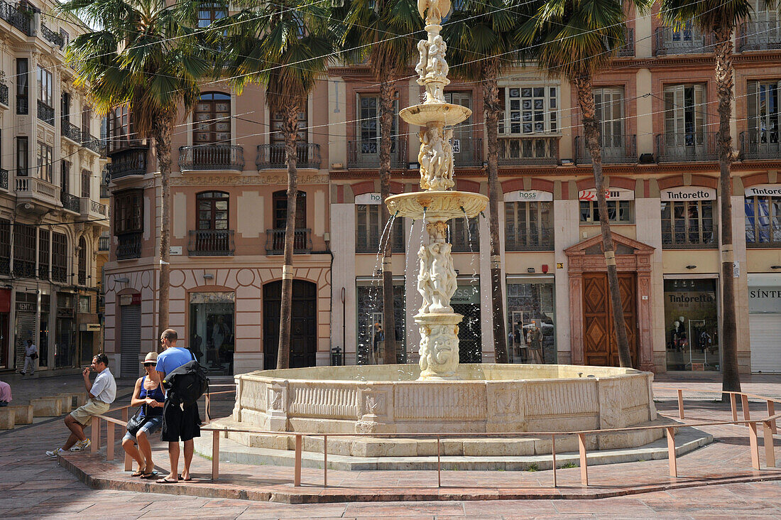 Fountain and people at the Plaza de la Constitucion, Malaga, Andalusia, Spain, Europe