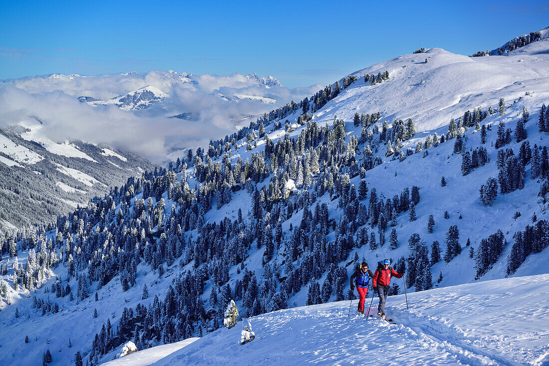 Two persons back-country skiing ascending towards Pallspitze, Pallspitze, Langer Grund, Kitzbuehel range, Tyrol, Austria