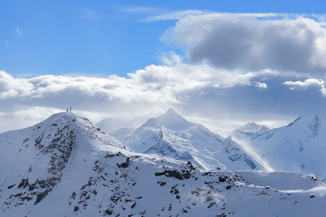 Person standing at summit of Aleitenspitze, in background Wildkarspitze, from Schafsiedel, Kurzer Grund, Kitzbuehel range, Tyrol, Austria