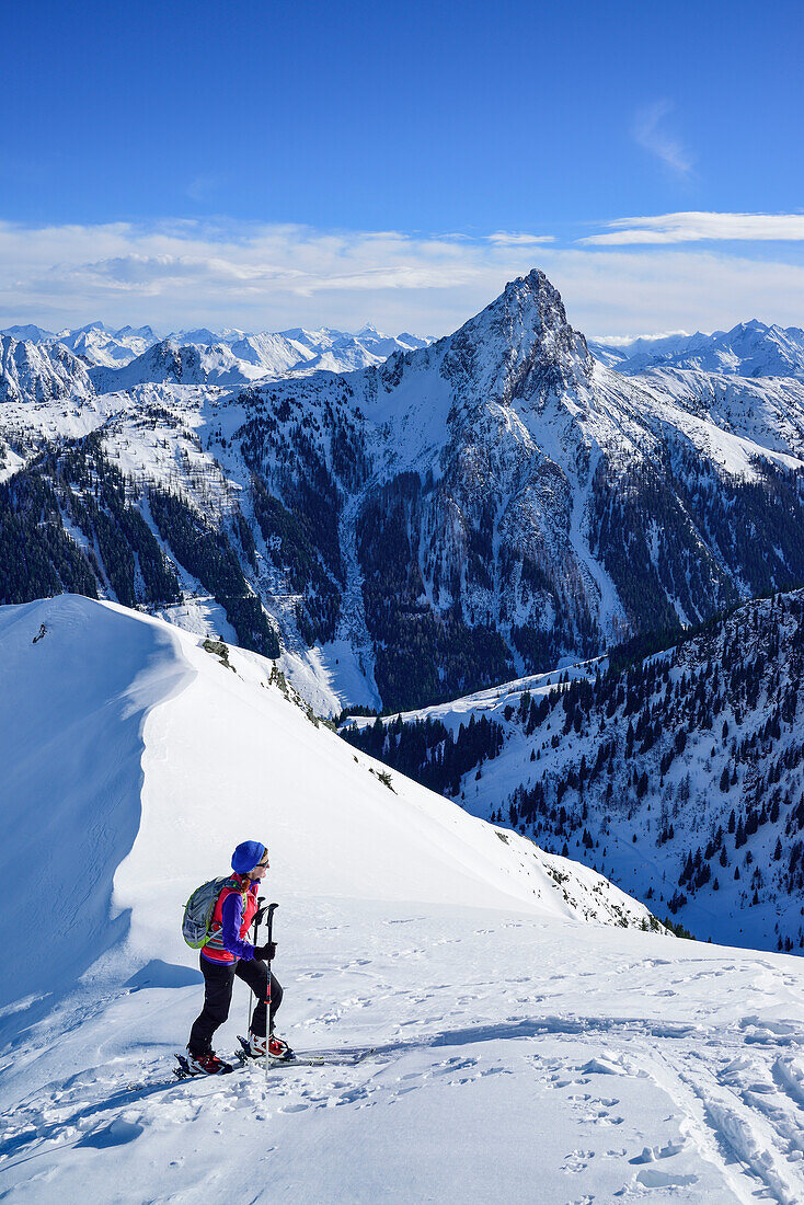 Woman back-country skiing asending towards Floch, Grosser Rettenstein in background, Floch, valley of Spertental, Kitzbuehel range, Tyrol, Austria