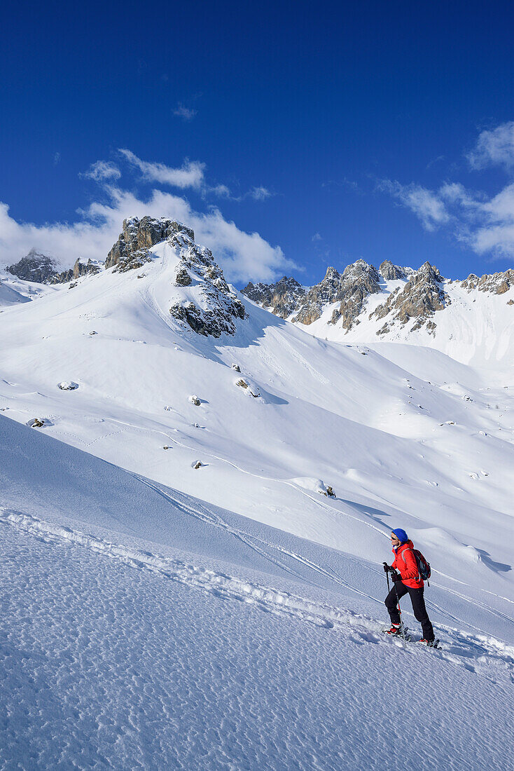 Woman back-country skiing ascending towards Monte Soubeyran, Monte Soubeyran, Valle Maira, Cottian Alps, Piedmont, Italy