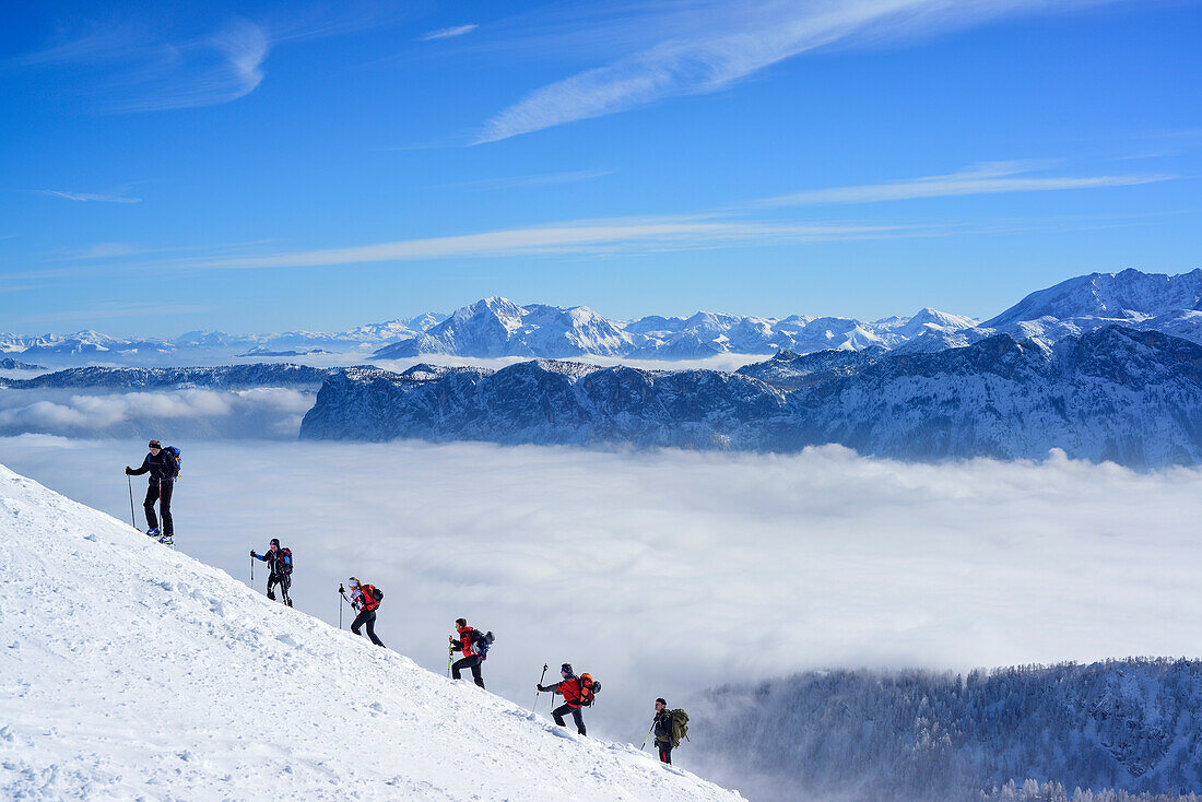 Group of persons back-country skiing ascending towards Sonntagshorn, Berchtesgaden range in background, Sonntagshorn, Chiemgau range, Salzburg, Austria