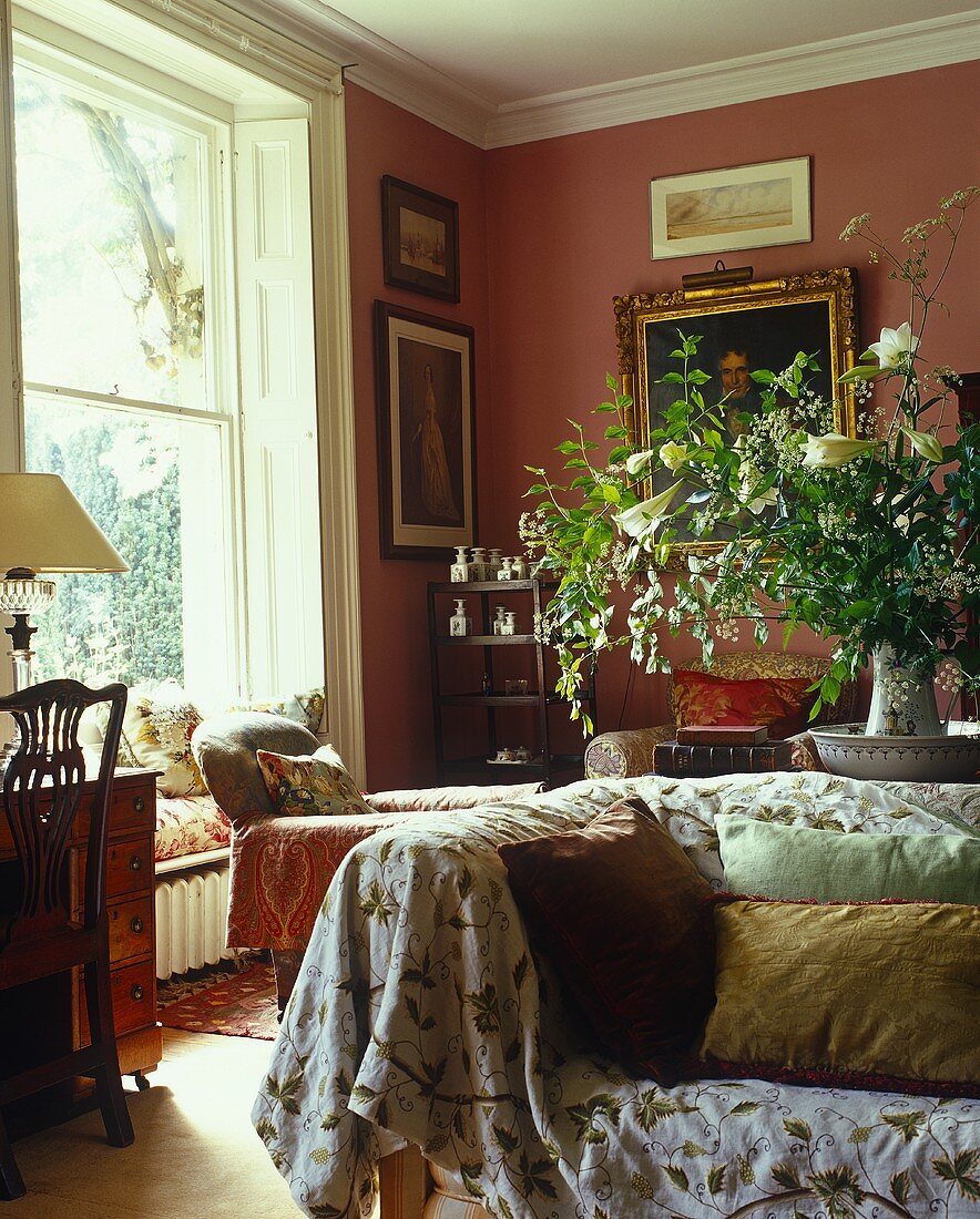 Traditional living room corner in red hues with sofa and cushions