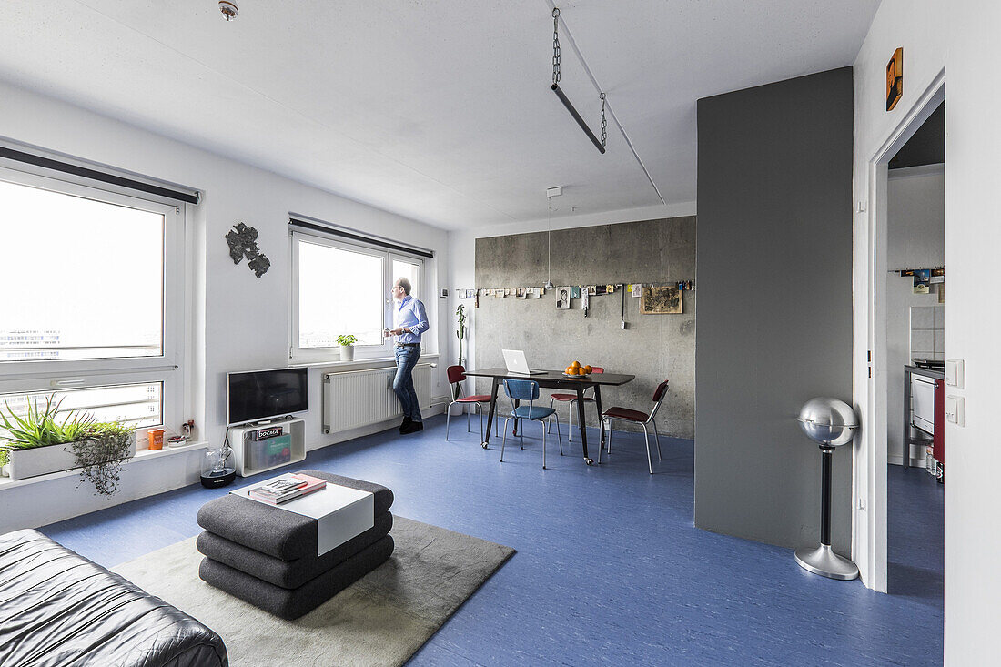 man in a modern prefab apartment in Berlin, Alexanderplatz, Berlin, Germany