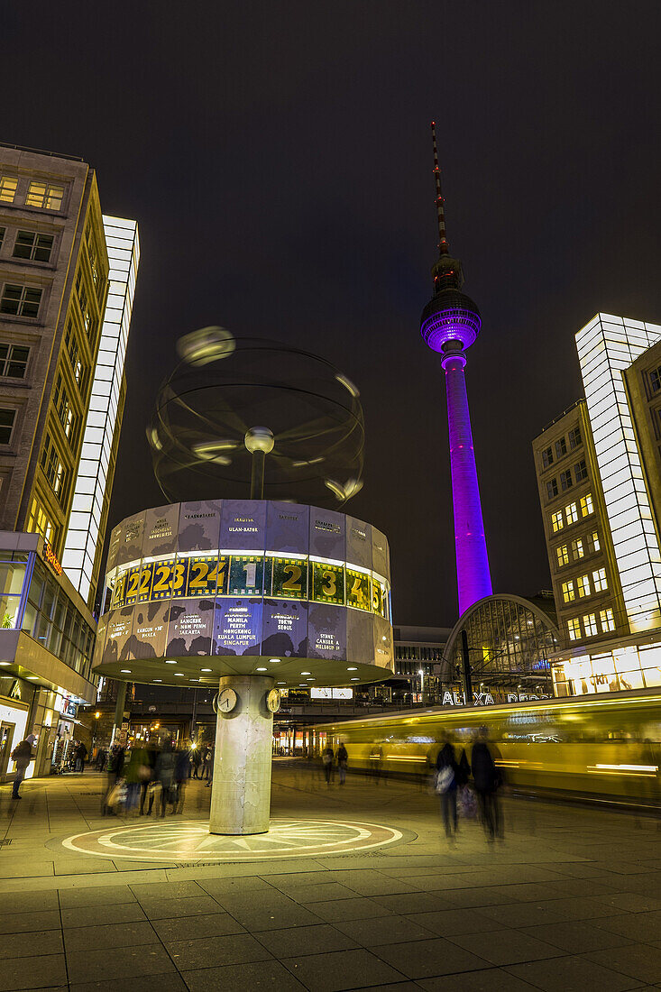 World clock at Alexanderplatz and view towards Alex at night, Berlin, Germany