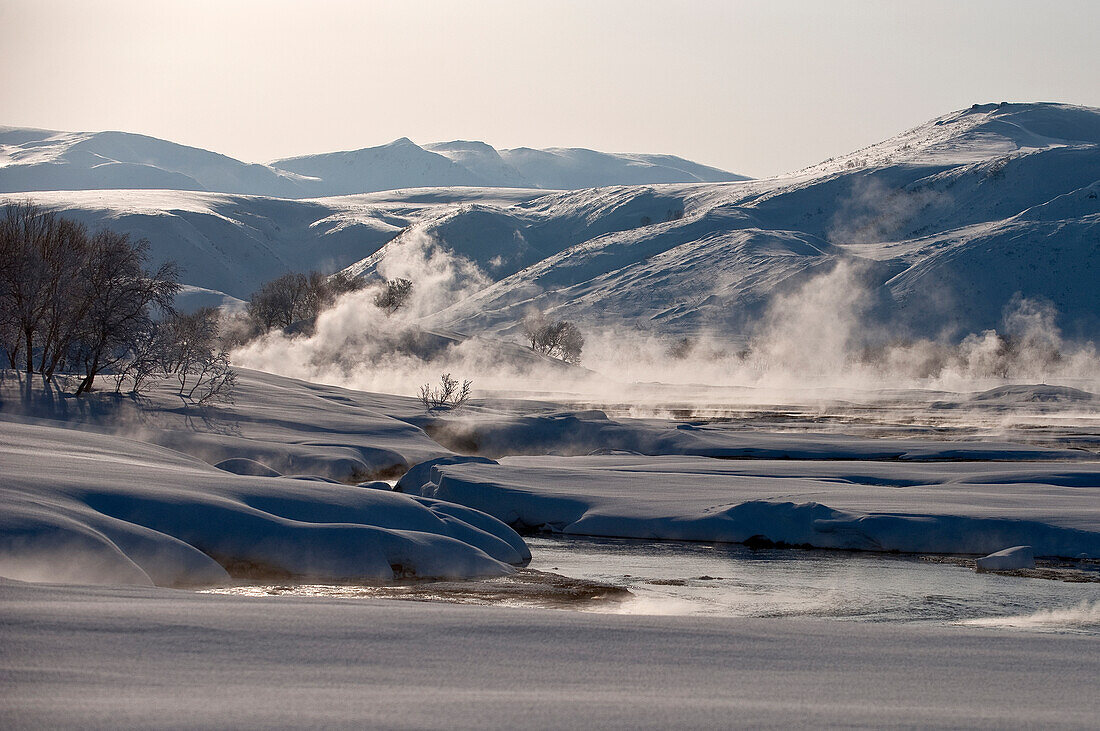 Steam coming off river in winter, Kamchatka, Russia