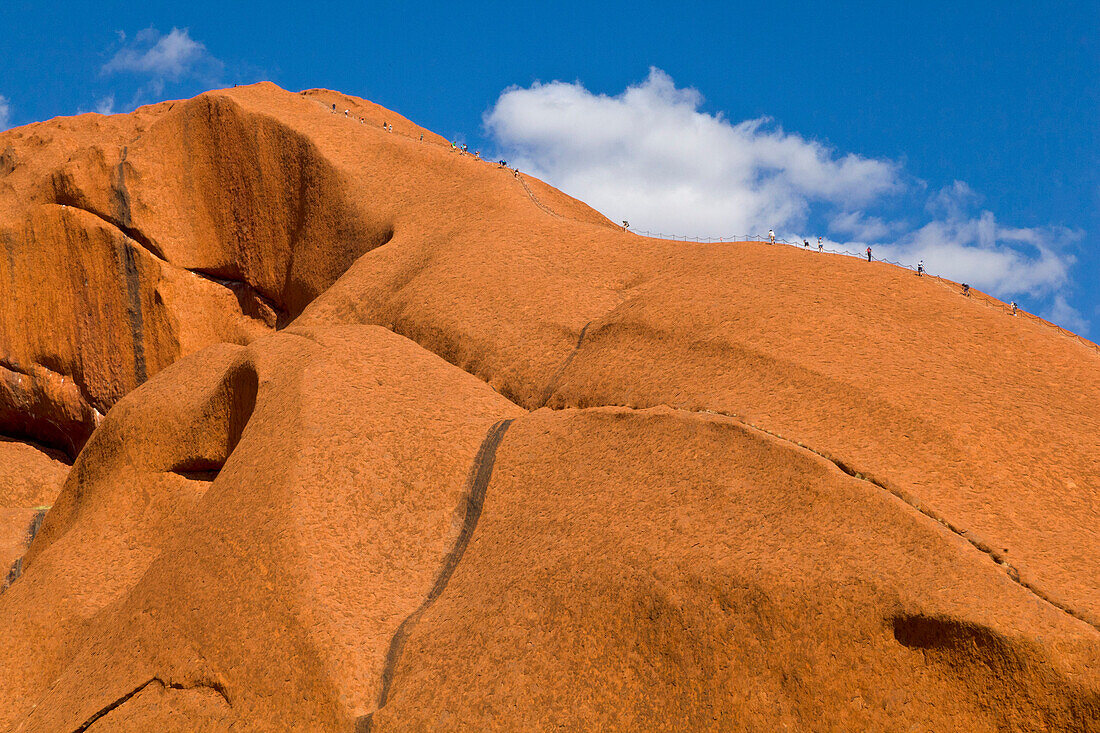 Tourists climbing Ayers Rock, Uluru-kata Tjuta National Park, Northern Territory, Australia