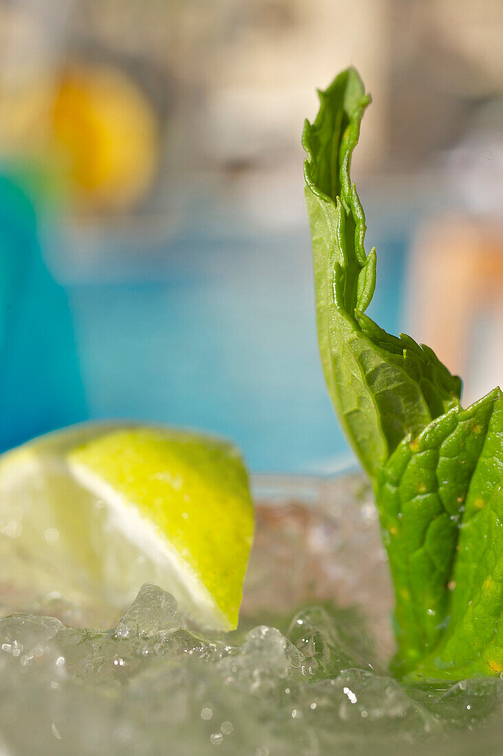 Lemon and green mint leaves and ice in a cocktail glass at the pool bar in Le Meridien Hotel, Limassol, Limassol District, Cyprus
