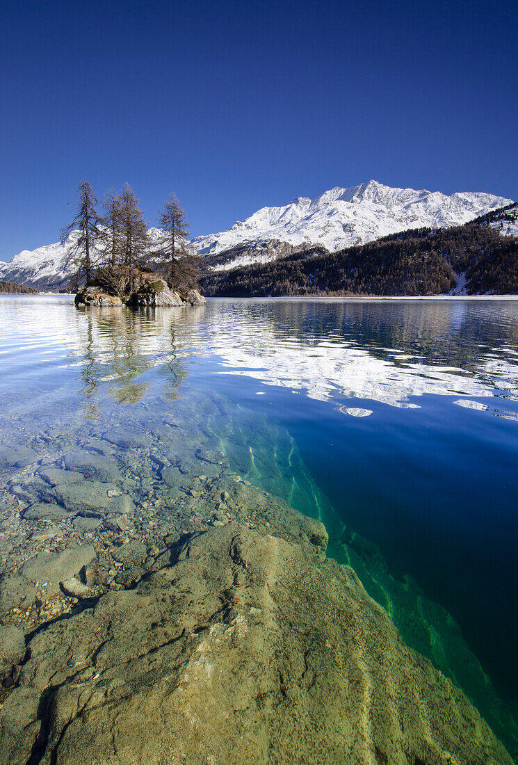 Ground of Lake Sils and a small island near Plaun da Lej with Isola on the opposite shore, Engadin, Grisons, Switzerland