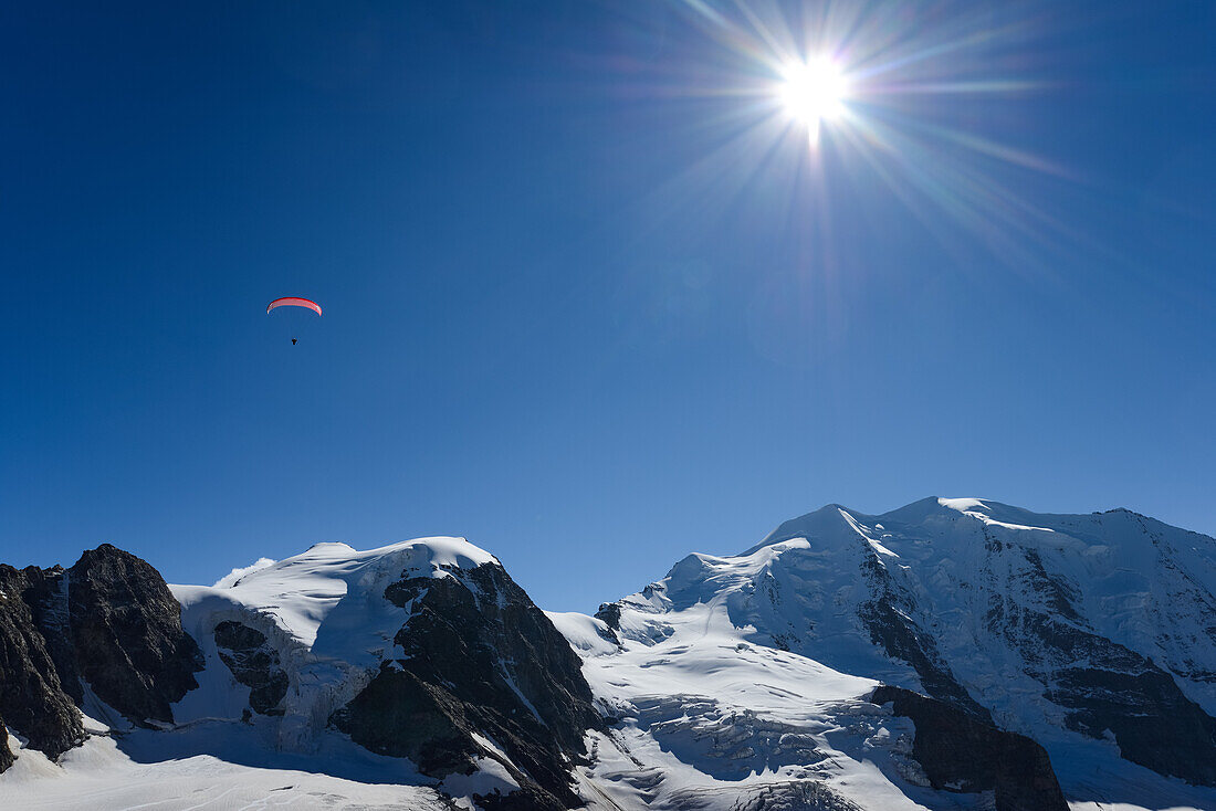 Paraglider above Piz Cambrena (3602 m) and Piz Palue (3905 m), Engadin, Grisons, Switzerland
