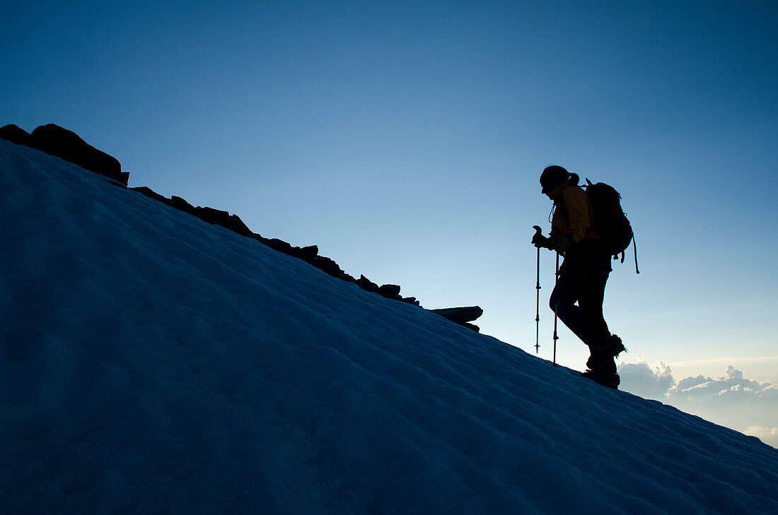 A female alpinist on the south ridge of the Weissmies, Pennine Alps, canton of Valais Switzerland