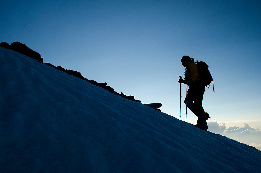 Eine Bergsteigerin früh morgens auf dem Südgrat des Weissmies, Walliser Alpen, Kanton Wallis, Schweiz