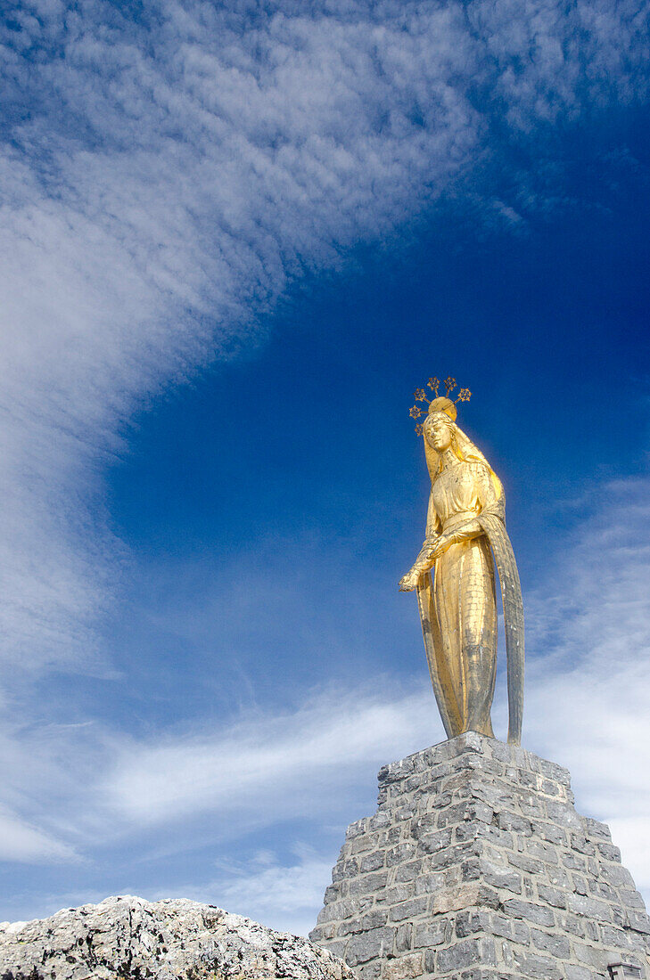 Golden statue of the Virgin Mary on the Monte Moro Pass, Pennine Alps, canton of Valais, Region of Piedmont, national border of Switzerland and Italy