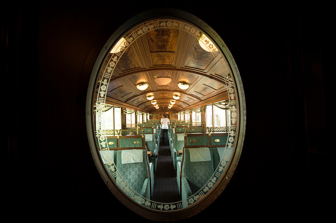 View through a decorated door window into one of the historic wagons of the Golden Pass Railway travelling on the Montreux-Bernese Oberland railway, cantons of Vaud and Bern, Switzerland