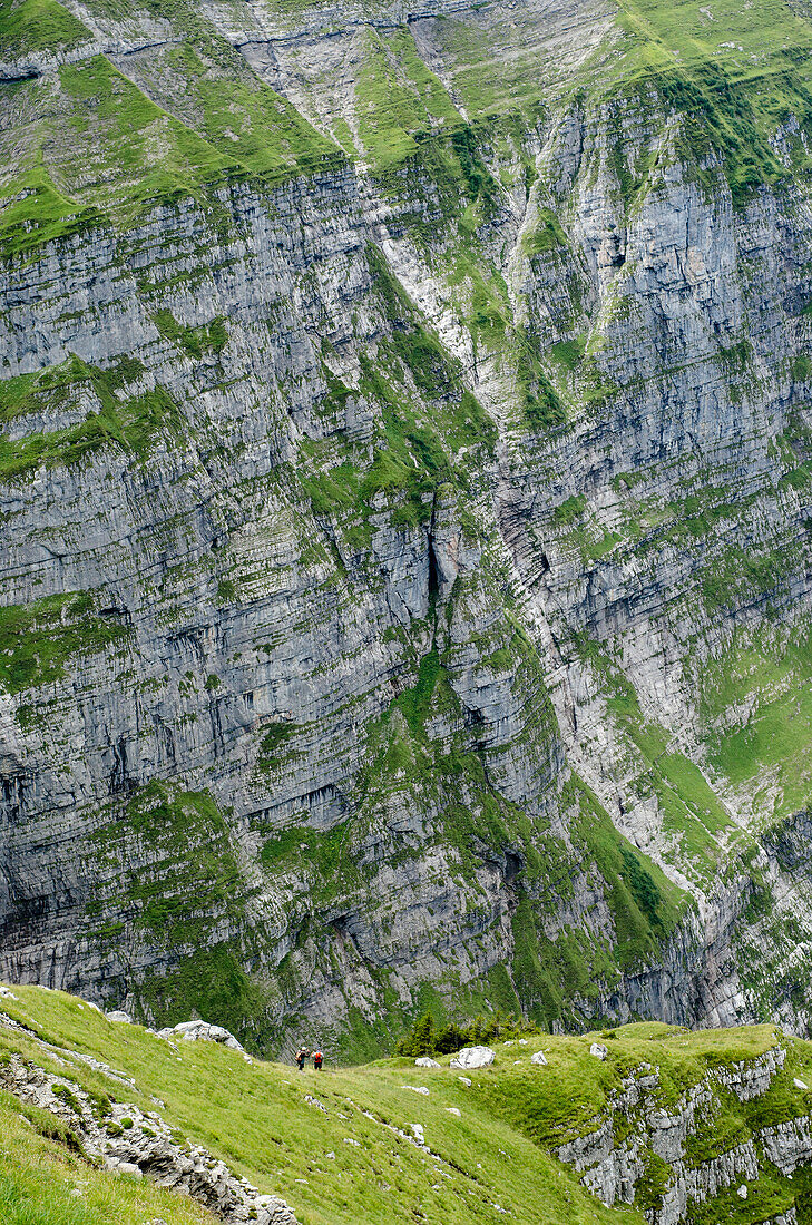 Two hikers descending from the summit of the Vorder Glaernisch, mountain massif of Glaernisch, Glarus Alps, canton of Glarus, Switzerland