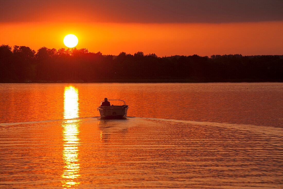 Electric Motorboat at sunset, Herreninsel, Chiemsee, Bavaria, Germany