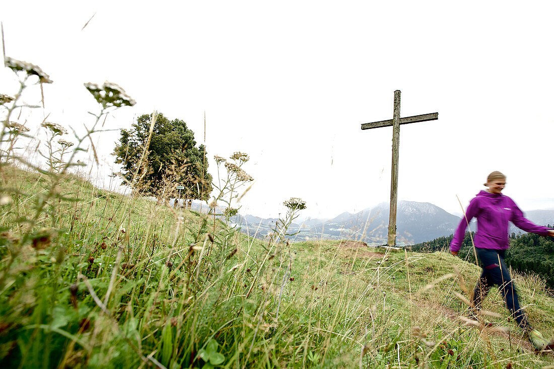 Woman hiking in the mountains, Chiemgau, Bavaria, Germany