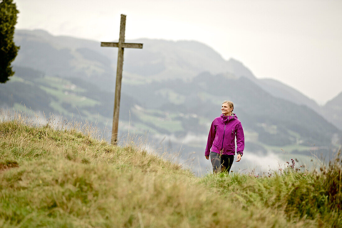 Woman hiking in the mountains, Chiemgau, Bavaria, Germany