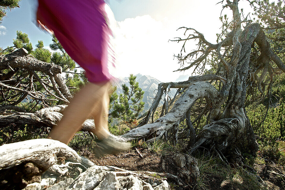 Young woman hiking in the mountains on a sunny day, Oberstdorf, Bavaria, Germany