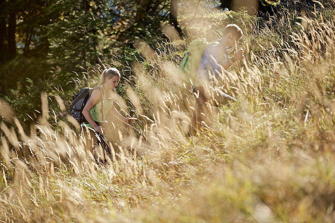 A man and a woman hiking in the mountains, Oberstdorf, Bavaria, Germany