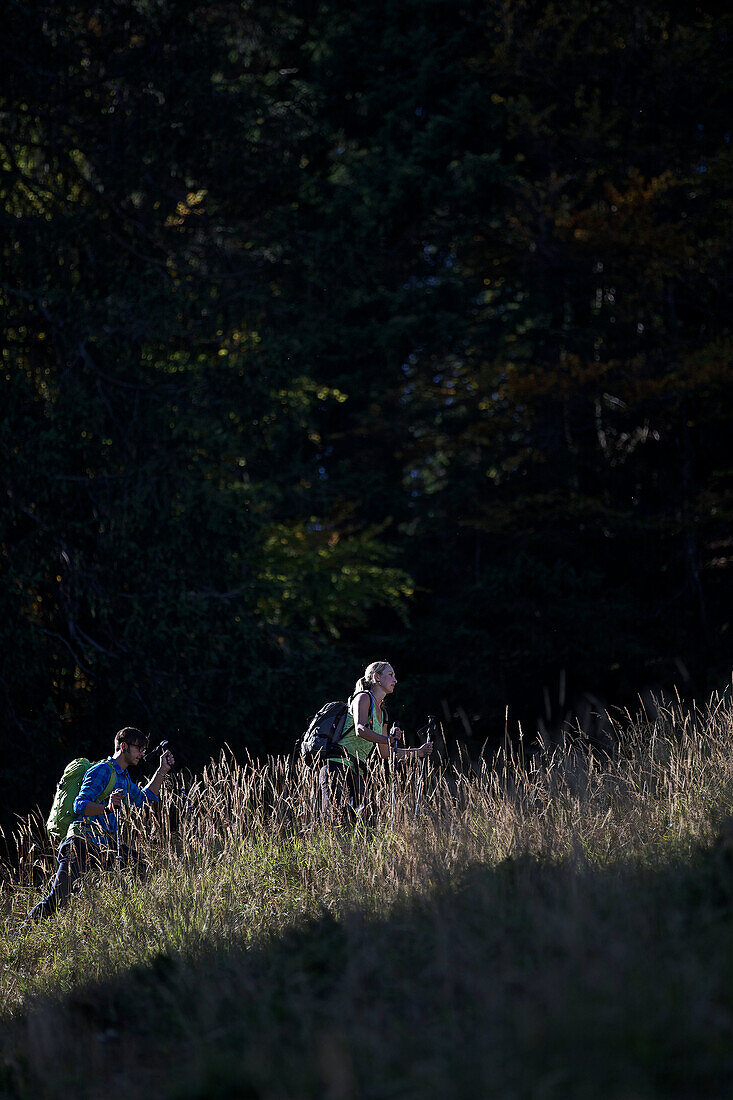 A man and a woman hiking in the mountains, Oberstdorf, Bavaria, Germany