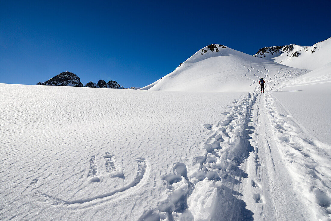 Smiley in the snow next to the ascension tracks with a ski-tourer, Grisons, Switzerland, Europe