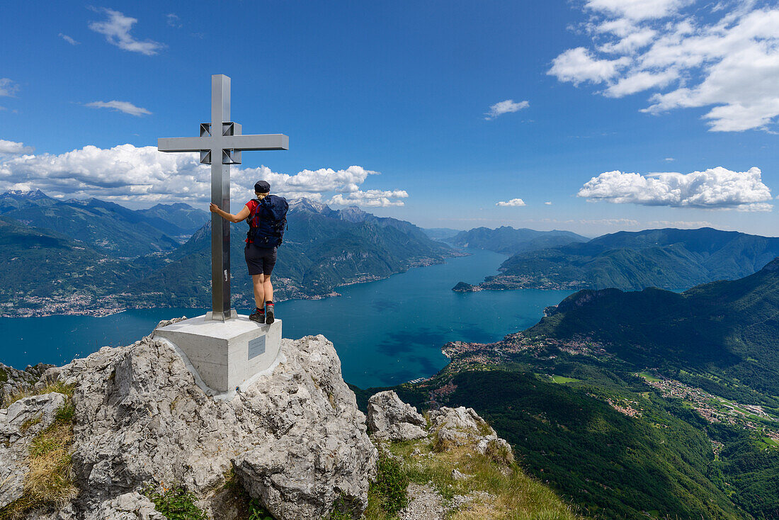 Woman at the peak of Grona (1736 m) in front of Menaggio at the shore of Lake Como and Grigna Settentrionale (2408 m) above, Lombardei, Italy