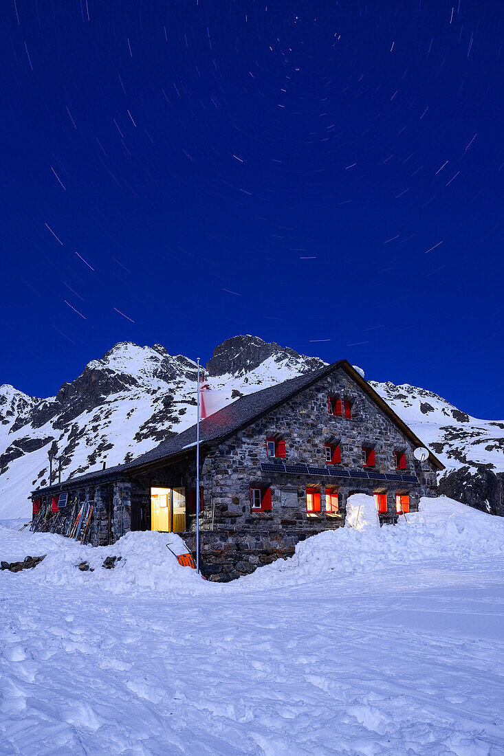 Vollmond an der Grialetschhütte (2542 m) mit Piz Radönt (3065 m) und Sternenkarussell darüber, Graubünden, Schweiz, Europa