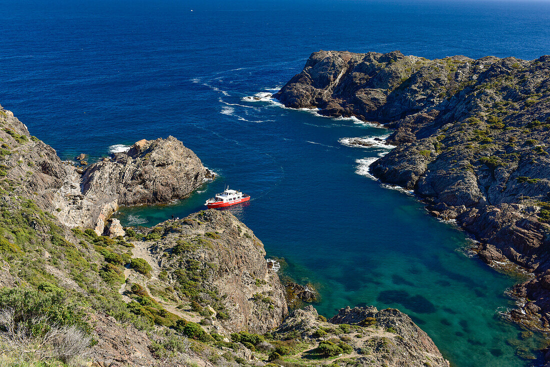 excursion boat cruising into a bay at Cap de Creus (Cabo de Creus),  nature park, most eastern point of Spain, Mediterranean Sea, Costa Brava, Catalonia, Spain