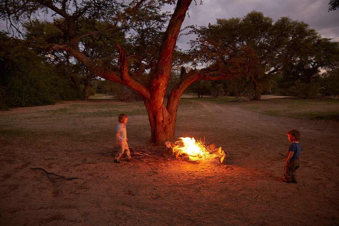 Two boys near a campfire, Hoarusib river, Namib desert, Nambia