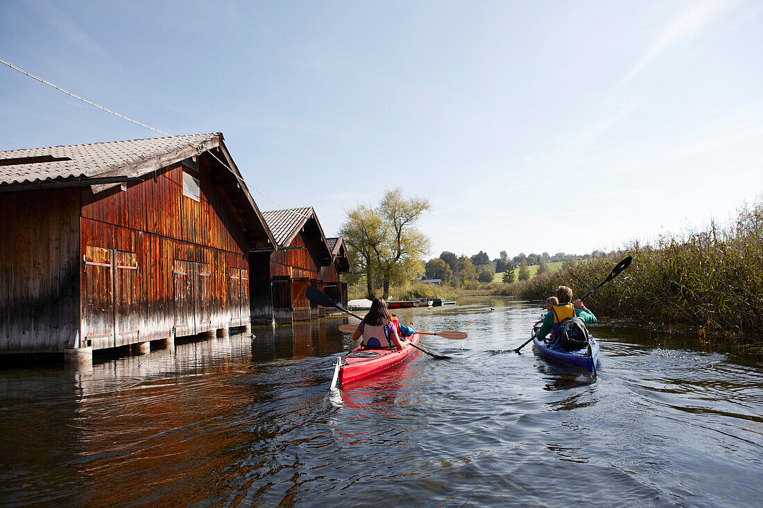 Family canoe touring on lake Staffelsee, Seehausen, Upper Bavaria, Germany