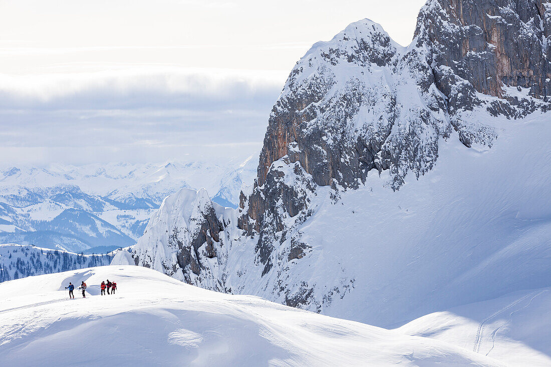Backcountry skiers under Riffl peak, Tennengebirge mountains, Salzburg, Austria
