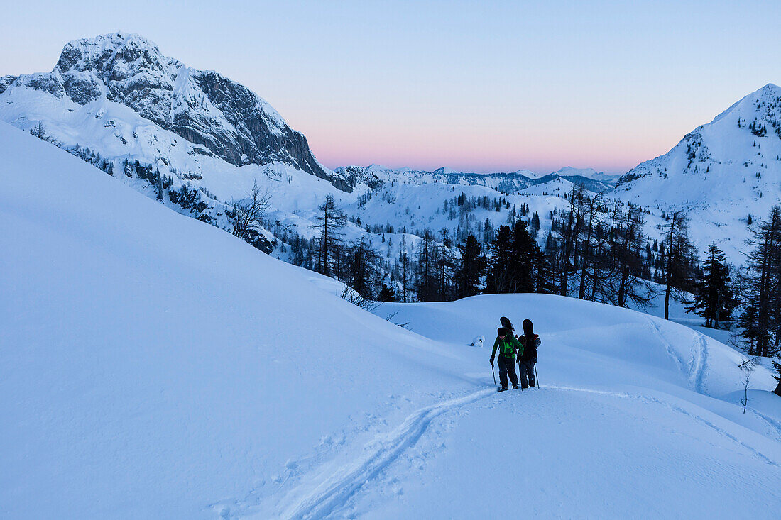 Backcountry skiers at dawn, Tennengebirge mountains, Salzburg, Austria
