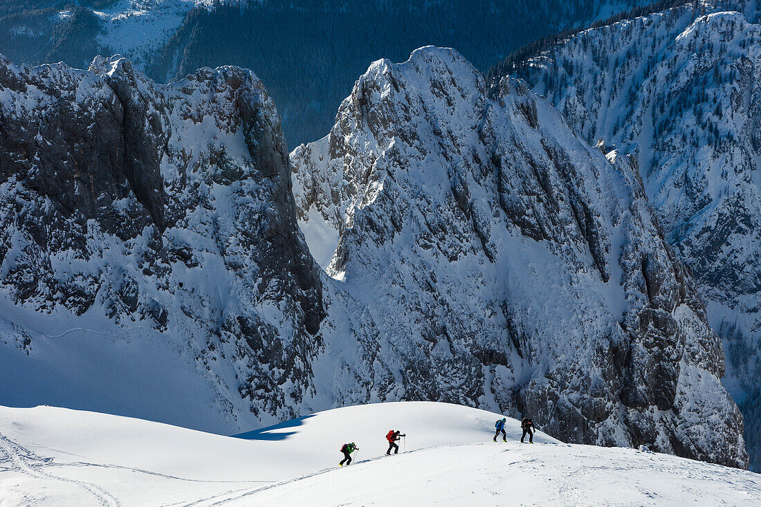Backcountry skiers ascending Hochkarfelderkopf, Tennengebirge mountains, Salzburg, Austria
