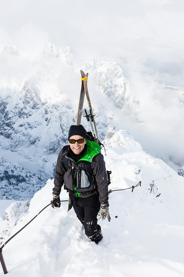 Ski mountaineer ascending via ferrata, Alpspitz, Garmisch-Partenkirchen, Upper Bavaria, Germany