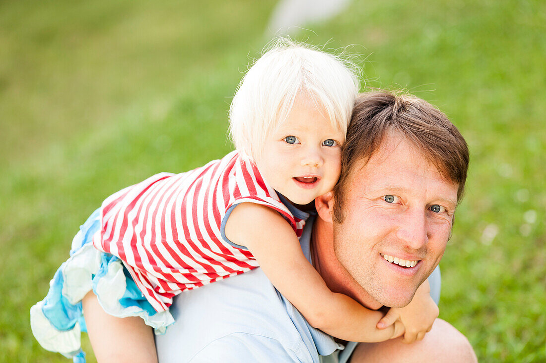 two-year-old girl on her father's back, Speyer, Rheinland-Pfalz, Germany