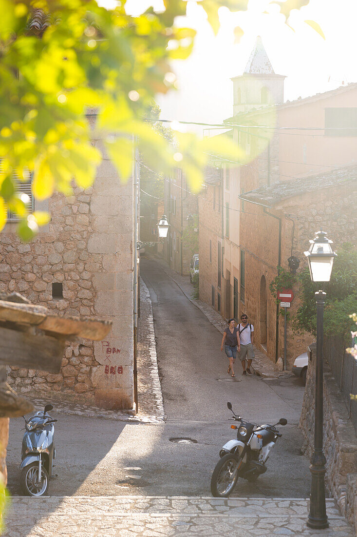 couple walking down an alley, romantic mountain village, Lemon tree, Biniaraix, Serra de Tramuntana, Majorca, Balearic Islands, Spain, Europe