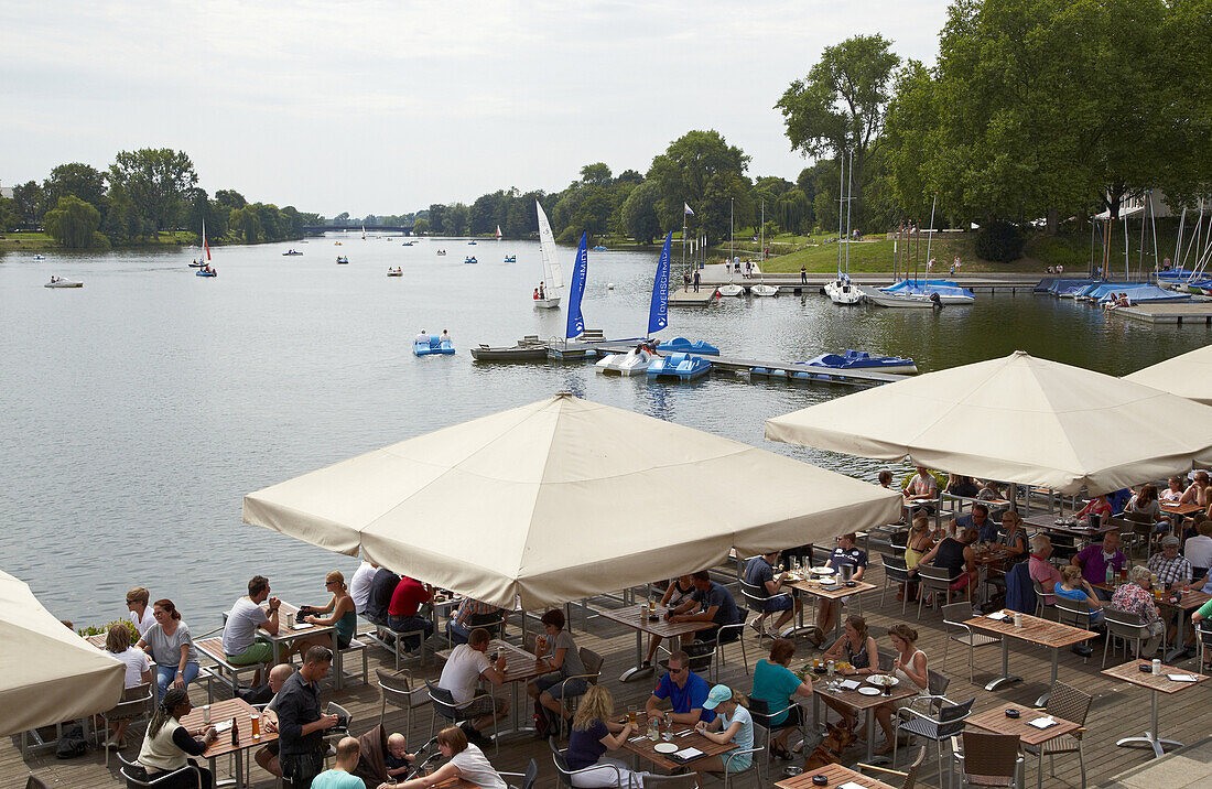 Boats and garden restaurant at the Aasee , Muenster , Muensterland , North Rhine-Westphalia , Germany , Europe