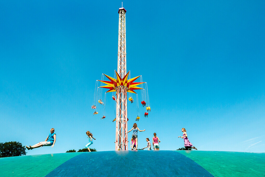 Theme park with swing carousel and trampoline, Hansapark, Sierksdorf, Baltic Coast, Schleswig-Holstein, Germany