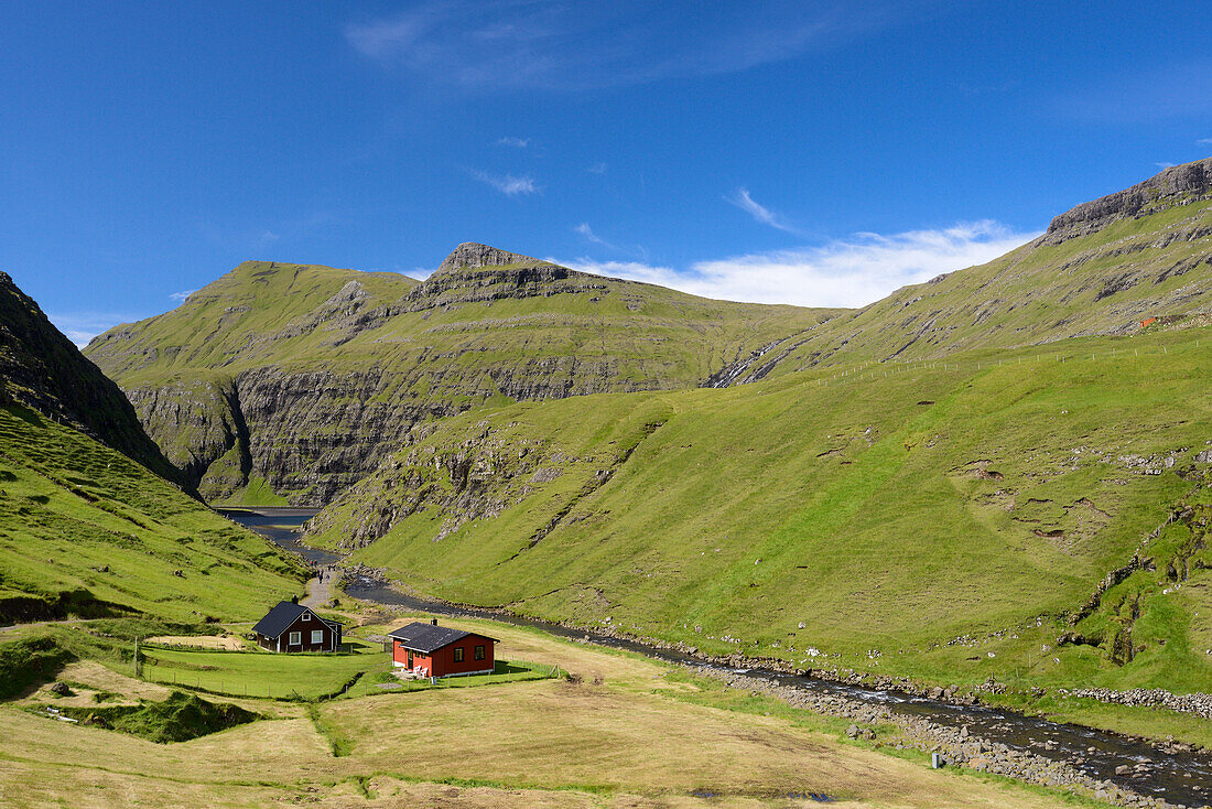 Stream, weekend houses and a lake in Saksun, Streymoy Island, Faroe Islands