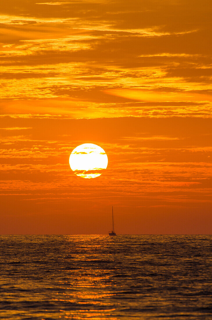 A sailing yacht in the sunset on the northern shore of Mallorca, Balearic Islands, Spain, Europe