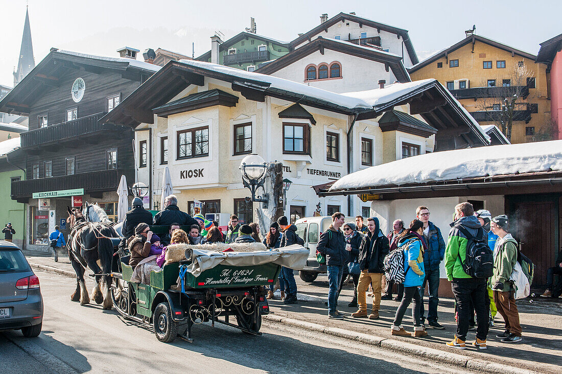 People enjoying a carriage ride through Kitzbuehel, Tyrol, Austria, Europe