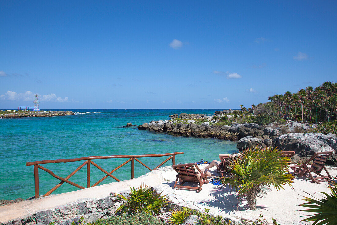 Lounge chairs and coastline at Xel-Ha Water Park, Tulum, Riviera Maya, Quintana Roo, Mexico