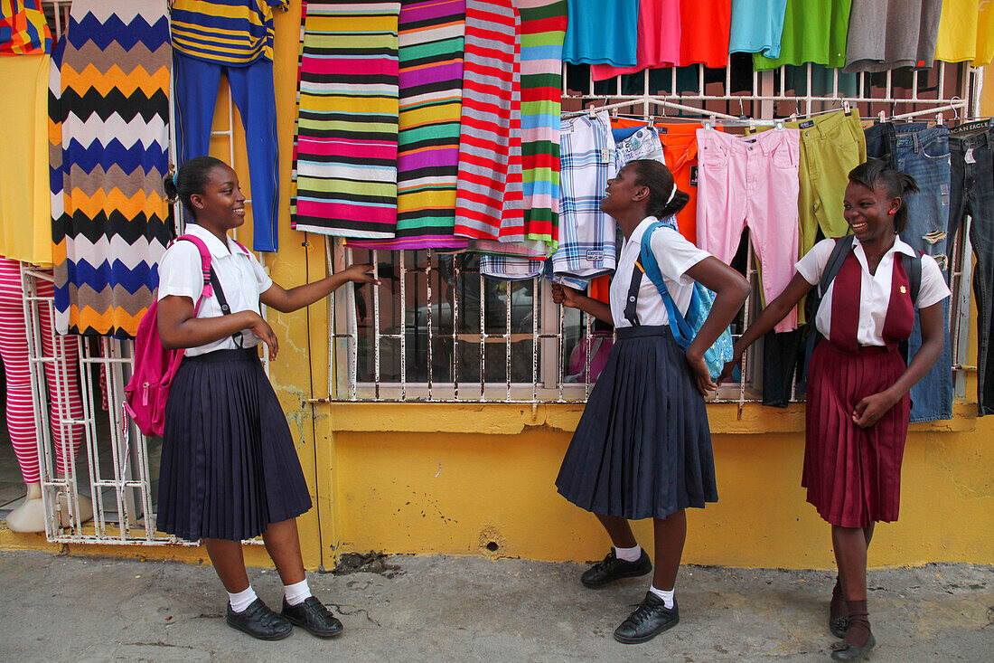 Teenage girls in school uniforms share a laugh, Port Antonio, Portland, Jamaica