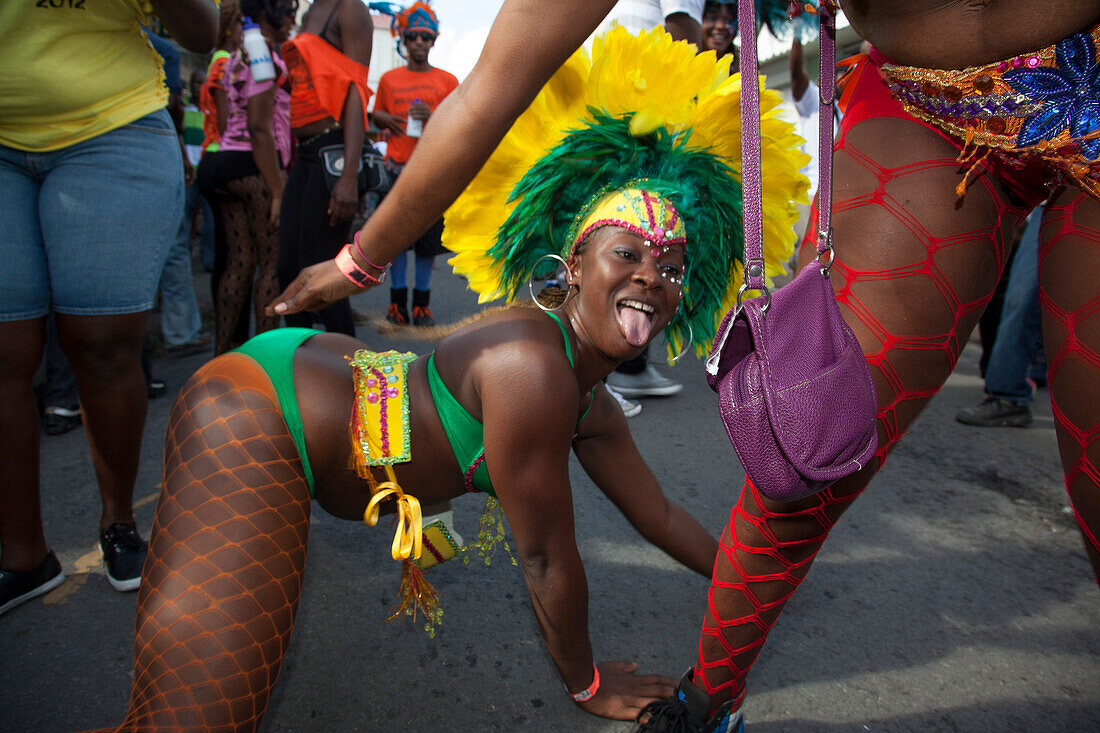 Women in costume dance in street at parade celebrating begin of carnival season, St. John's, St. John, Antigua, Antigua and Barbuda