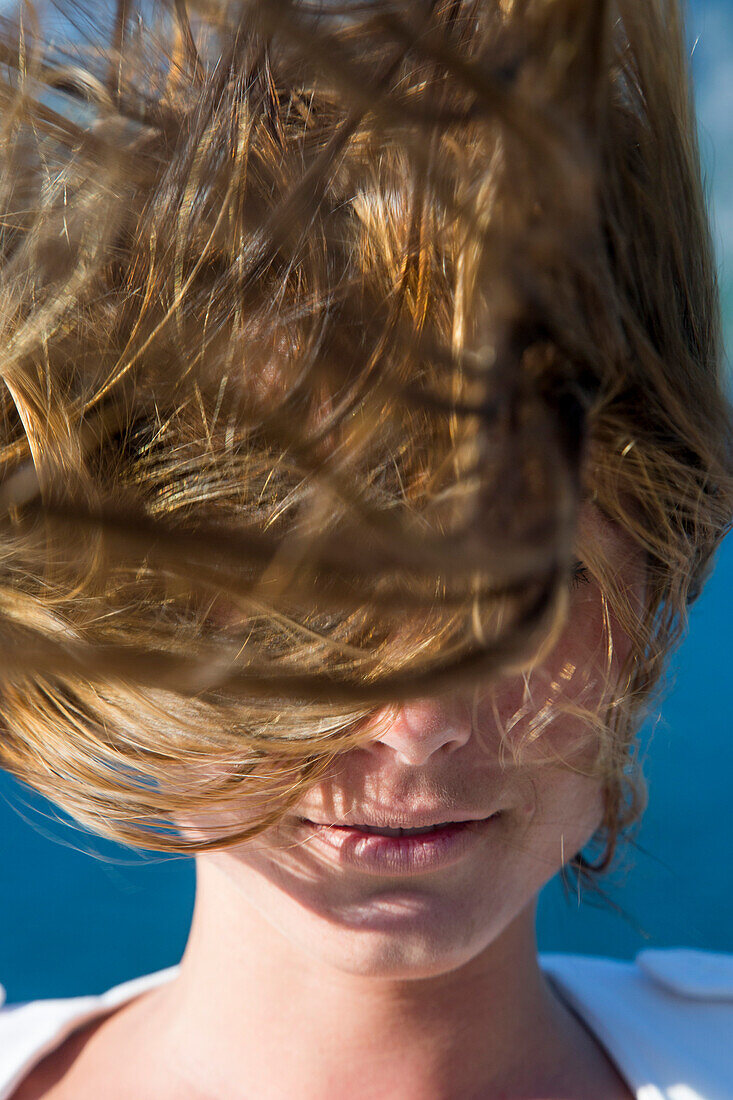 Windblown hair of young woman aboard cruise ship MS Deutschland (Reederei Peter Deilmann), near Stordal, More og Romsdal, Norway
